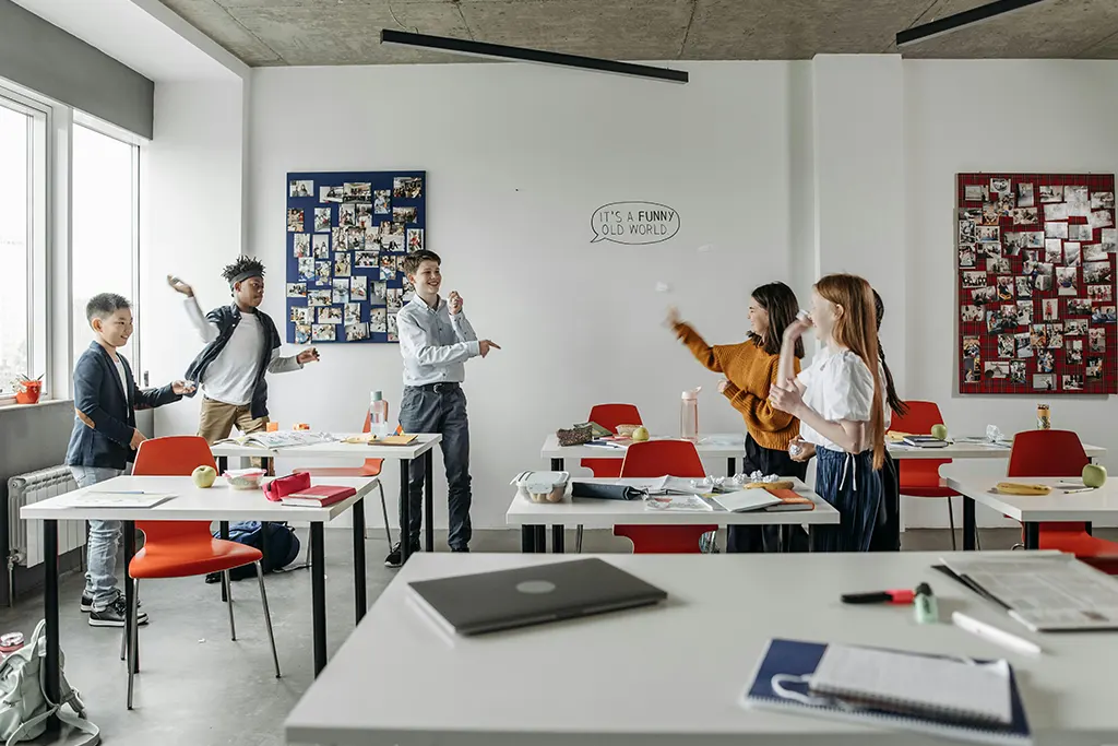 Five Kids inside classroom throwing and playing The Impact of a Clean Campus: A Magnet for Success